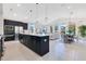 Modern, open-concept kitchen with stainless steel appliances, center island and eat in space, seamlessly connected to the living area at 744 Curly Locks Loop, Apopka, FL 32703