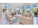 Bright and airy living room featuring large windows with backyard views and comfortable seating arrangements at 744 Curly Locks Loop, Apopka, FL 32703