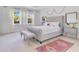 Bright primary bedroom featuring large windows, tufted headboard, and stylish decor at 744 Curly Locks Loop, Apopka, FL 32703