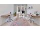 Bright home office with a decorative rug, and dual desk spaces at 744 Curly Locks Loop, Apopka, FL 32703