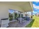 Covered patio with outdoor dining set and grill, great for entertaining at 744 Curly Locks Loop, Apopka, FL 32703