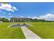 Shaded picnic area in a grassy park featuring picnic tables under a shelter, perfect for community gatherings at 744 Curly Locks Loop, Apopka, FL 32703