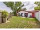 Home exterior with a large backyard and sliding doors leading to an outdoor patio that's perfect for entertaining and enjoying the outdoors at 8040 Sagebrush Pl, Orlando, FL 32822