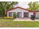 Home's exterior with sliding doors leading to a concrete patio and a large fenced yard with plenty of space for outdoor activities at 8040 Sagebrush Pl, Orlando, FL 32822