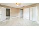 Neutral bedroom featuring a ceiling fan, neutral paint, and white closet doors at 8040 Sagebrush Pl, Orlando, FL 32822