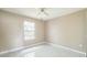 Bright bedroom featuring tile floors, neutral paint, and a window at 8040 Sagebrush Pl, Orlando, FL 32822