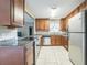 Renovated kitchen with stainless steel appliances, granite counters, and wood cabinets at 8040 Sagebrush Pl, Orlando, FL 32822
