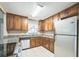 Updated kitchen featuring granite countertops, stainless steel appliances, and wood cabinetry at 8040 Sagebrush Pl, Orlando, FL 32822