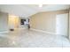 Bright living room featuring tile floors, neutral paint, and access to the kitchen at 8040 Sagebrush Pl, Orlando, FL 32822