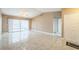 Spacious living room featuring glossy tile floors and sliding door access to outdoor patio at 8040 Sagebrush Pl, Orlando, FL 32822
