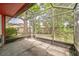 View of the screened porch with concrete flooring, which looks out onto the home's fenced backyard and lush green landscaping at 8040 Sagebrush Pl, Orlando, FL 32822