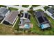 Aerial view of a house featuring a backyard pool, solar panels, and well-maintained landscaping at 831 Corvina Dr, Davenport, FL 33897