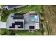 Aerial view of a house with a pool and solar panels on the roof at 831 Corvina Dr, Davenport, FL 33897