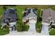 An aerial view of a two story home with solar panels and a well manicured lawn and driveway at 831 Corvina Dr, Davenport, FL 33897