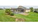 The backyard shows a pool, screened-in lanai, and plenty of green grass for recreation at 831 Corvina Dr, Davenport, FL 33897