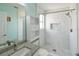Bright white tiled bathroom featuring a granite vanity and walk-in shower at 831 Corvina Dr, Davenport, FL 33897