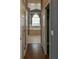 Hallway view of the main bathroom with double doors, and a large bathtub overlooking the window at 831 Corvina Dr, Davenport, FL 33897