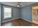 Calming bedroom with ceiling fan, window with blinds, and ensuite bathroom at 831 Corvina Dr, Davenport, FL 33897