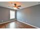 Bedroom featuring hardwood floors, a modern ceiling fan, and a window for natural light at 831 Corvina Dr, Davenport, FL 33897