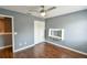 Comfortable bedroom with ceiling fan, built-in desk, closet, window, and hardwood floors at 831 Corvina Dr, Davenport, FL 33897