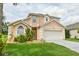 Beautiful two-story home with a well-kept lawn, offering a cozy and welcoming curb appeal at 831 Corvina Dr, Davenport, FL 33897