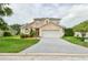 Charming two-story home featuring a well-maintained lawn and a two-car garage for convenience at 831 Corvina Dr, Davenport, FL 33897
