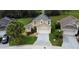 A two-story home with well-manicured landscaping and a two car garage with solar panels on the roof at 831 Corvina Dr, Davenport, FL 33897