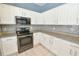 Kitchen offers stainless steel appliances, granite countertops, and tile backsplash at 831 Corvina Dr, Davenport, FL 33897