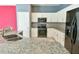 Kitchen with granite counters, stainless appliances, and white cabinetry at 831 Corvina Dr, Davenport, FL 33897