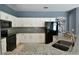 This kitchen features granite countertops, white cabinets, and stainless steel appliances at 831 Corvina Dr, Davenport, FL 33897