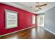 Bright living room featuring hardwood floors, neutral walls, and ample natural light from large windows at 831 Corvina Dr, Davenport, FL 33897