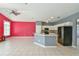 Open-concept living room and kitchen features stainless steel appliances and tile flooring at 831 Corvina Dr, Davenport, FL 33897
