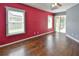 Bright bedroom features a window and sliding glass door to the screened patio at 831 Corvina Dr, Davenport, FL 33897