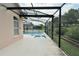 Beautiful screened-in in-ground pool area with outdoor living space and a jacuzzi at 831 Corvina Dr, Davenport, FL 33897