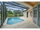 The crystal clear in-ground pool has an adjacent jacuzzi and screened-in lanai at 831 Corvina Dr, Davenport, FL 33897