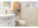 Bathroom featuring a modern vessel sink, toilet, and complementary wooden storage at 845 Edgewater Cir, Eustis, FL 32726