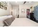 A cozy bedroom features neutral walls, a closet, and a decorative picture frame above the bed at 845 Edgewater Cir, Eustis, FL 32726