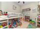 Bedroom with lofted bed, play area and lots of natural light at 845 Edgewater Cir, Eustis, FL 32726