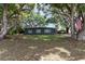 Charming single-story home with mature trees and a well-maintained front yard offering a serene setting at 845 Edgewater Cir, Eustis, FL 32726