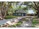 This single-story home has a well-manicured front lawn and a long driveway, providing ample parking at 845 Edgewater Cir, Eustis, FL 32726