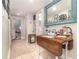 Hallway featuring a decorative table and a mirror creating a bright and welcoming space at 845 Edgewater Cir, Eustis, FL 32726