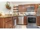 Kitchen featuring stainless appliances, granite countertops and wood cabinetry at 845 Edgewater Cir, Eustis, FL 32726