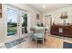 Eat-in kitchen area with dining table, ample cabinet space and door to backyard at 845 Edgewater Cir, Eustis, FL 32726