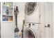 Efficient laundry area with stacked washer and dryer, complemented by adjacent shelving for organized storage at 845 Edgewater Cir, Eustis, FL 32726
