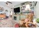 Open concept living room with a cozy fireplace, TV, and a comfortable seating area with stylish decor at 845 Edgewater Cir, Eustis, FL 32726