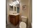 Bathroom featuring a toilet, sink, mirror, and neutral decor at 8894 Candy Palm Rd, Kissimmee, FL 34747