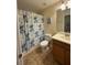 Bathroom featuring a toilet, sink, mirror, and Stitch-themed shower curtain at 8894 Candy Palm Rd, Kissimmee, FL 34747