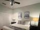 Comfortable bedroom featuring a ceiling fan, a plush queen-sized bed, and stylish wall decor at 8894 Candy Palm Rd, Kissimmee, FL 34747