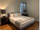 Well-lit bedroom featuring a comfortable bed and modern nightstands at 8894 Candy Palm Rd, Kissimmee, FL 34747