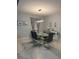 Elegant dining room featuring modern chandelier lighting, seating for six, and sleek marble tile flooring at 8894 Candy Palm Rd, Kissimmee, FL 34747